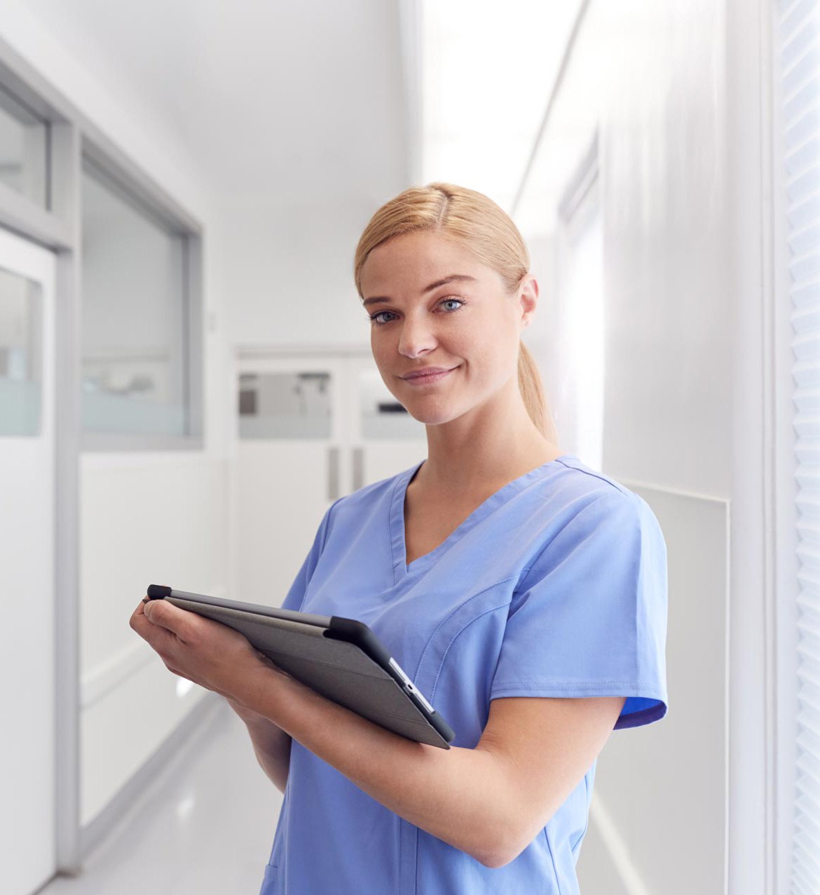 portrait-of-smiling-female-doctor-wearing-scrubs-EYSJKTB-1.jpg